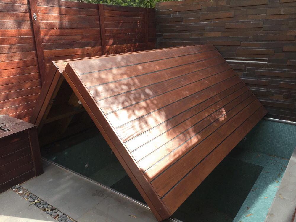 Premium automated plunge pool cover beginning to open on electric actuators